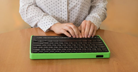 A person typing in Braille using a Braille keyboard