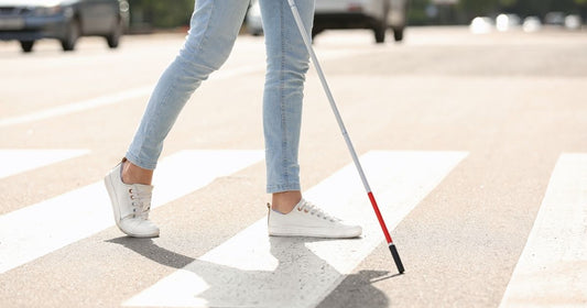 Blind woman crossing the street