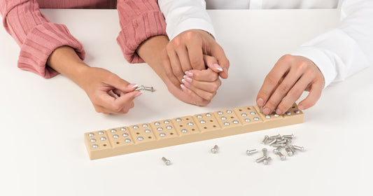 Blind person learning Braille with screws