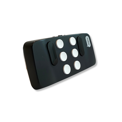 Hable One, a portable Braille keyboard in black, featuring six white buttons, two black navigation buttons, a switch to turn the device on and off, and a charging port.
